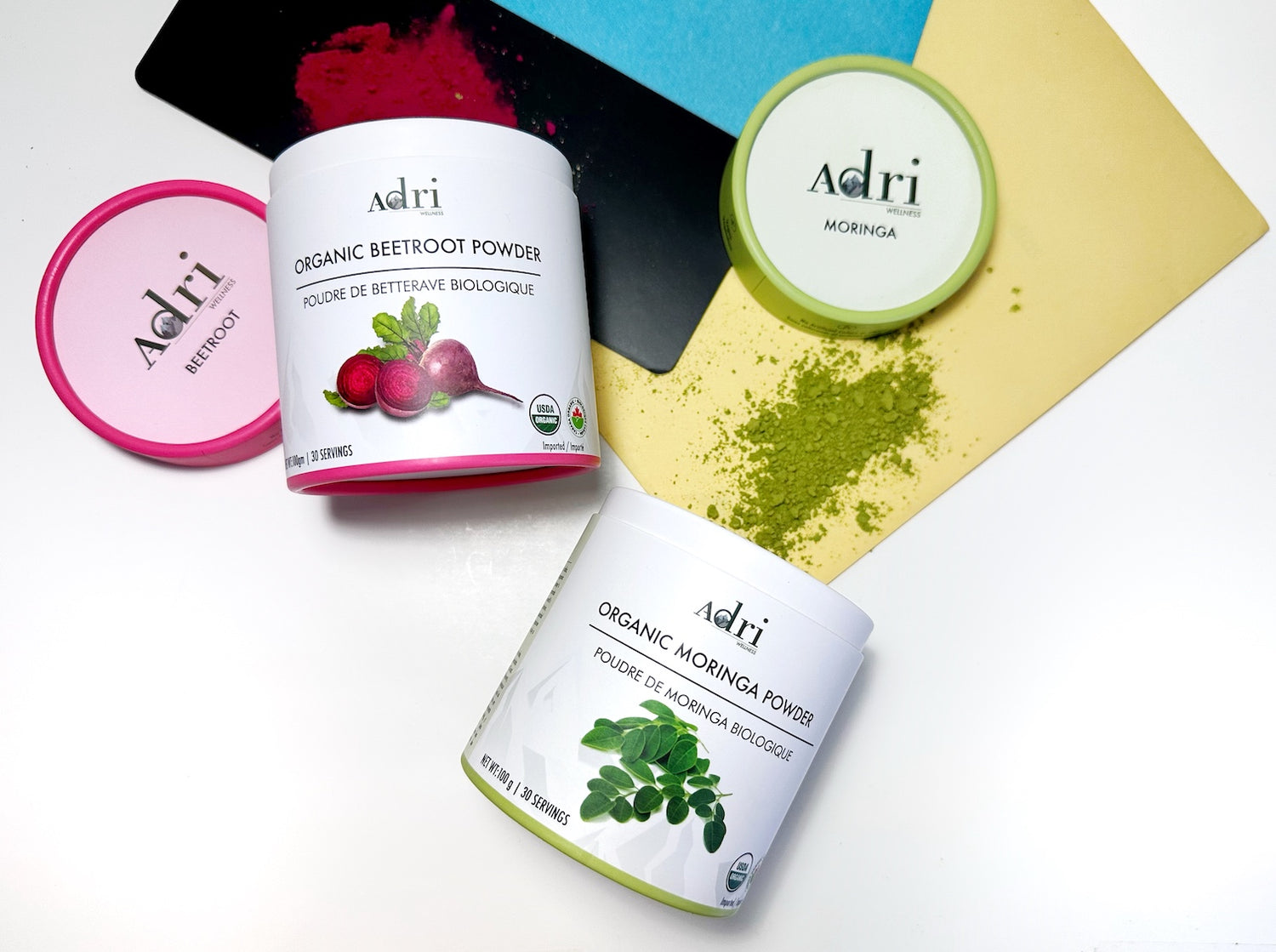 Adri Wellness Moringa and Beetroot powder scattered with their packaging