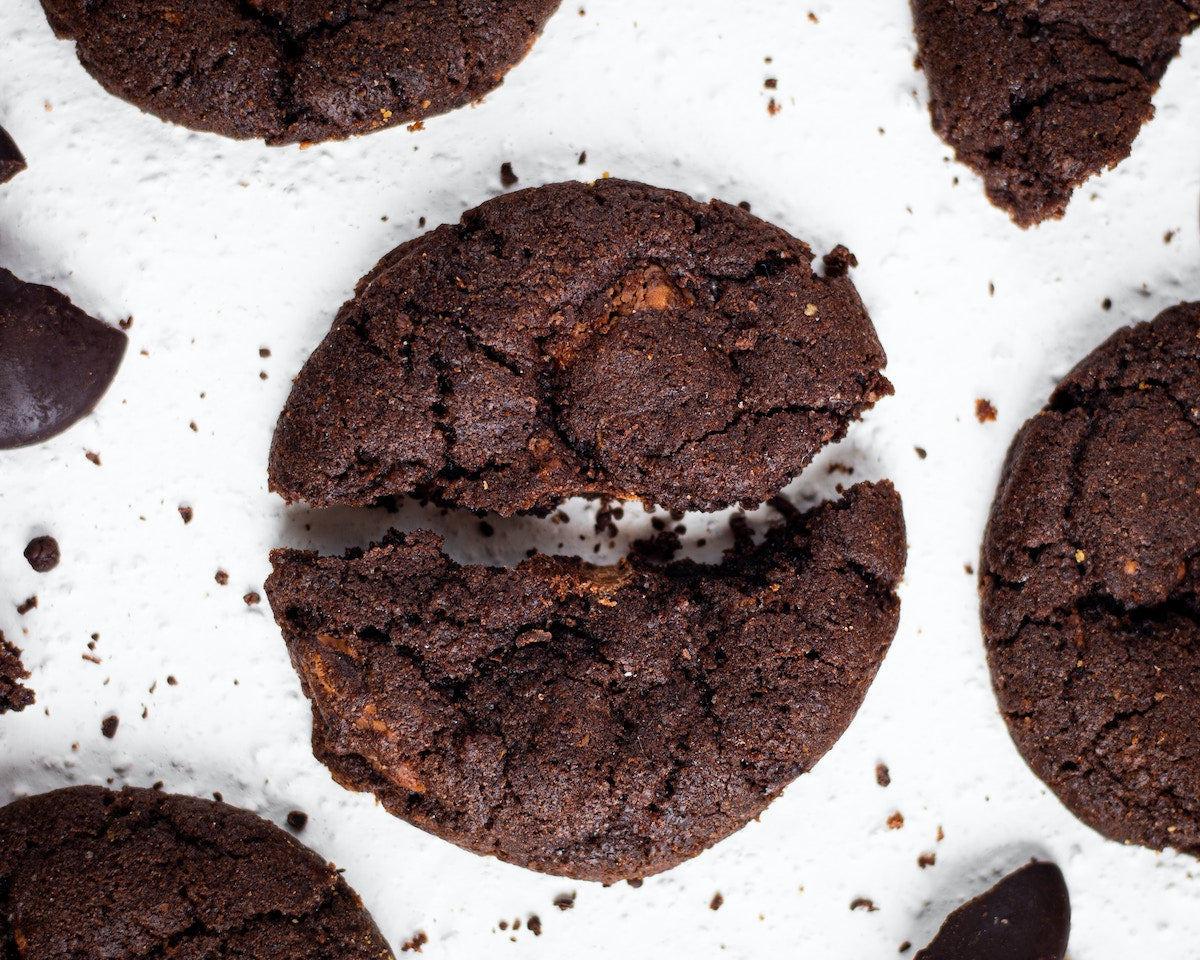Chocolate cookies made from Adri Wellness' Licorice powder placed on a white surface