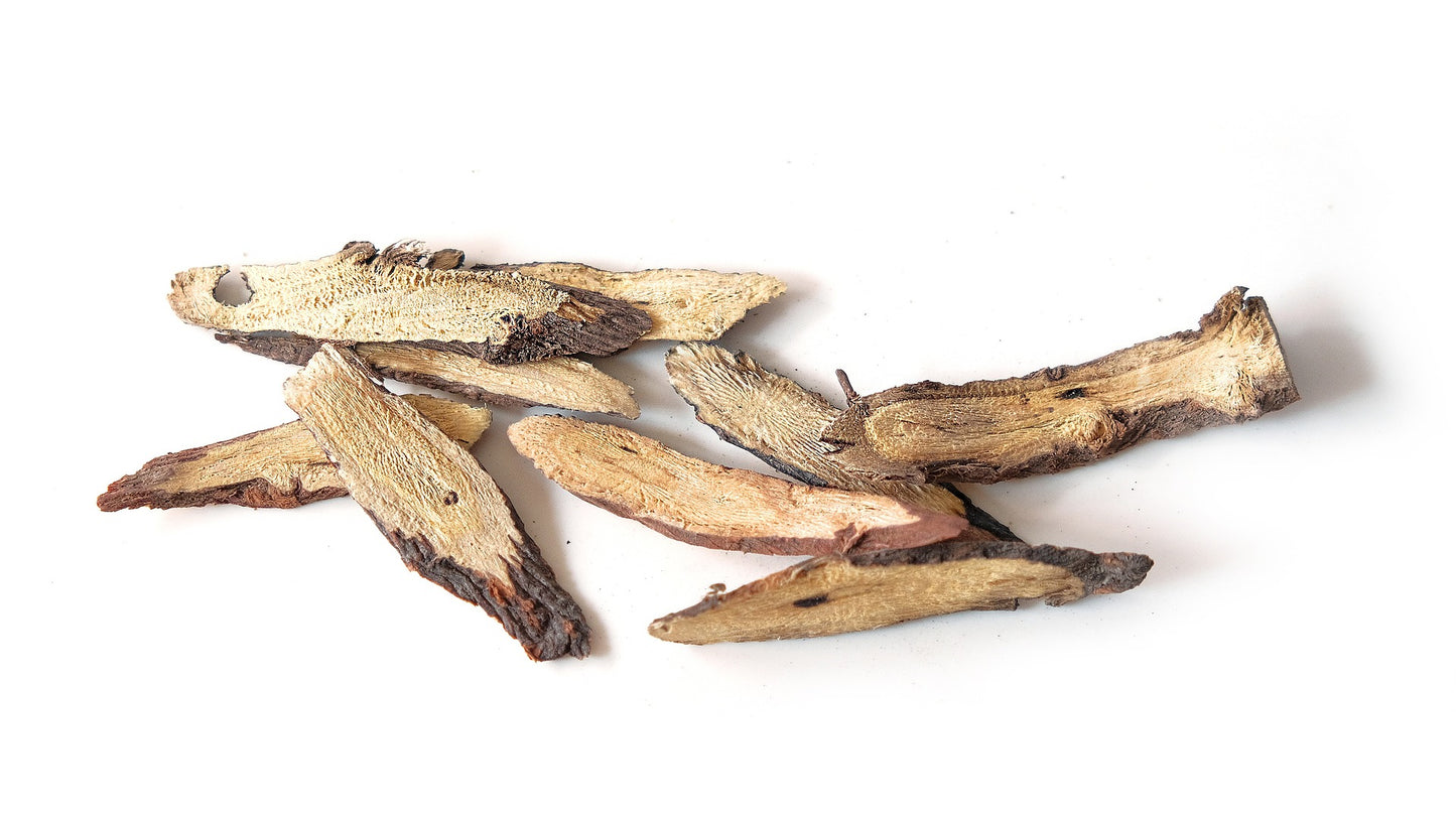 raw dried licorice root on a white background